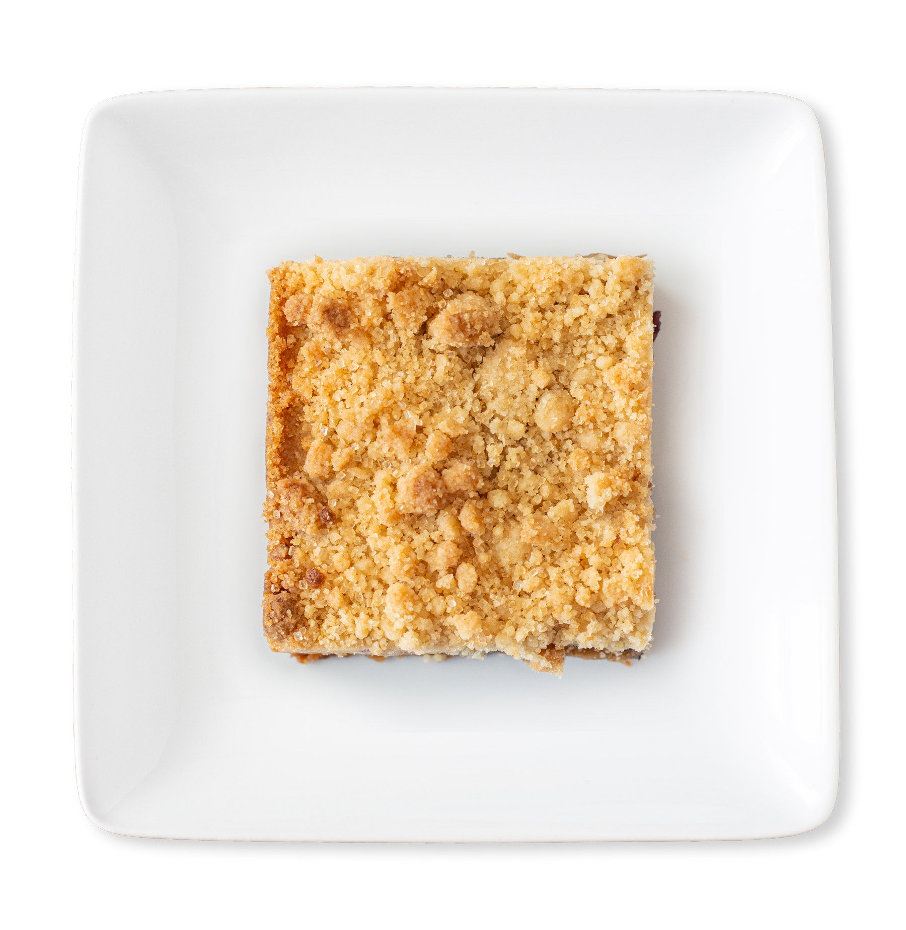 A close-up image of a Blueberry Crumb Blondie bar, showcasing its golden-brown crumb topping.