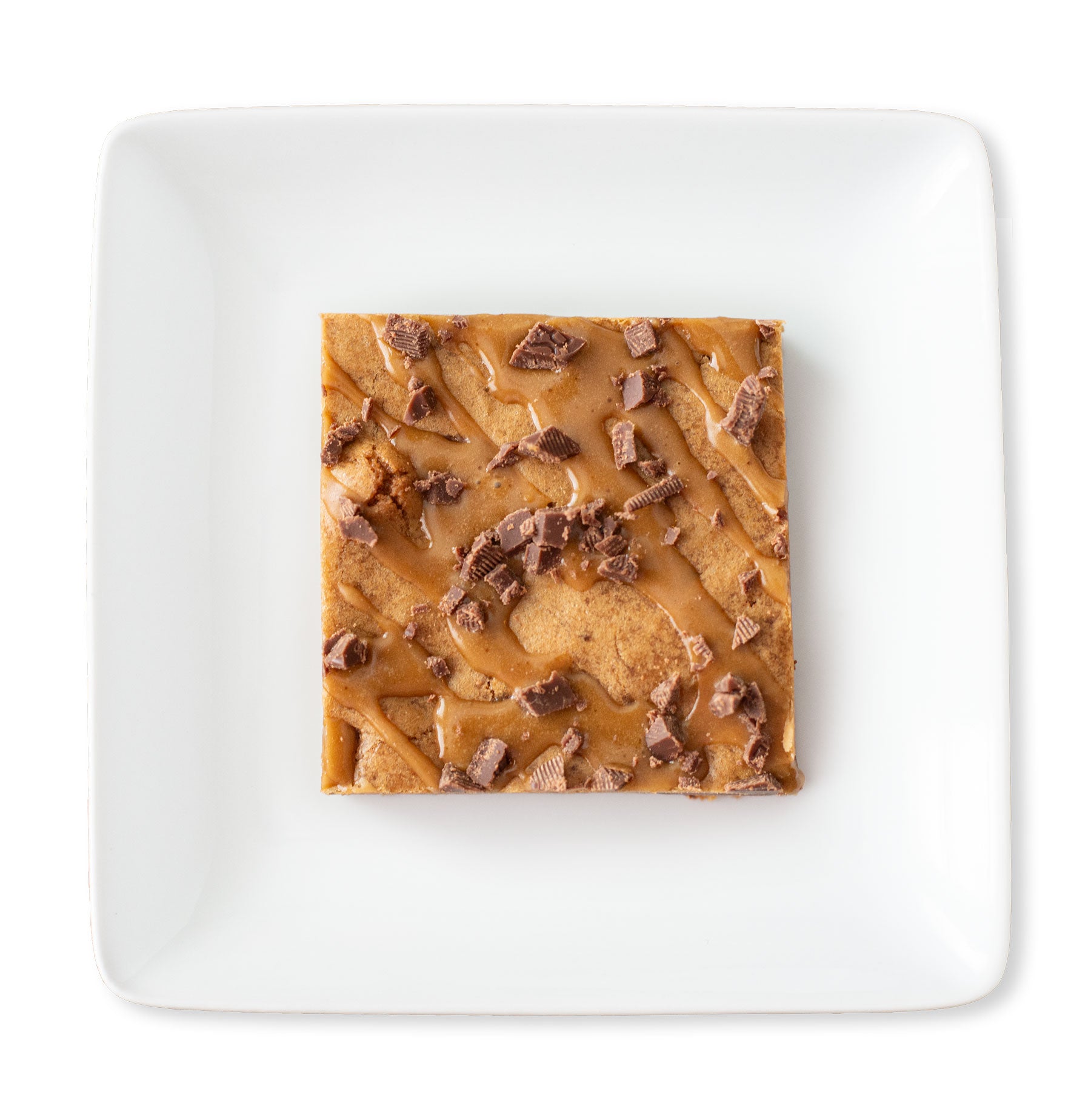 A close-up image of a Milk Chocolate Mocha Blondie, showcasing its dense and chewy texture, topped with a glossy espresso glaze