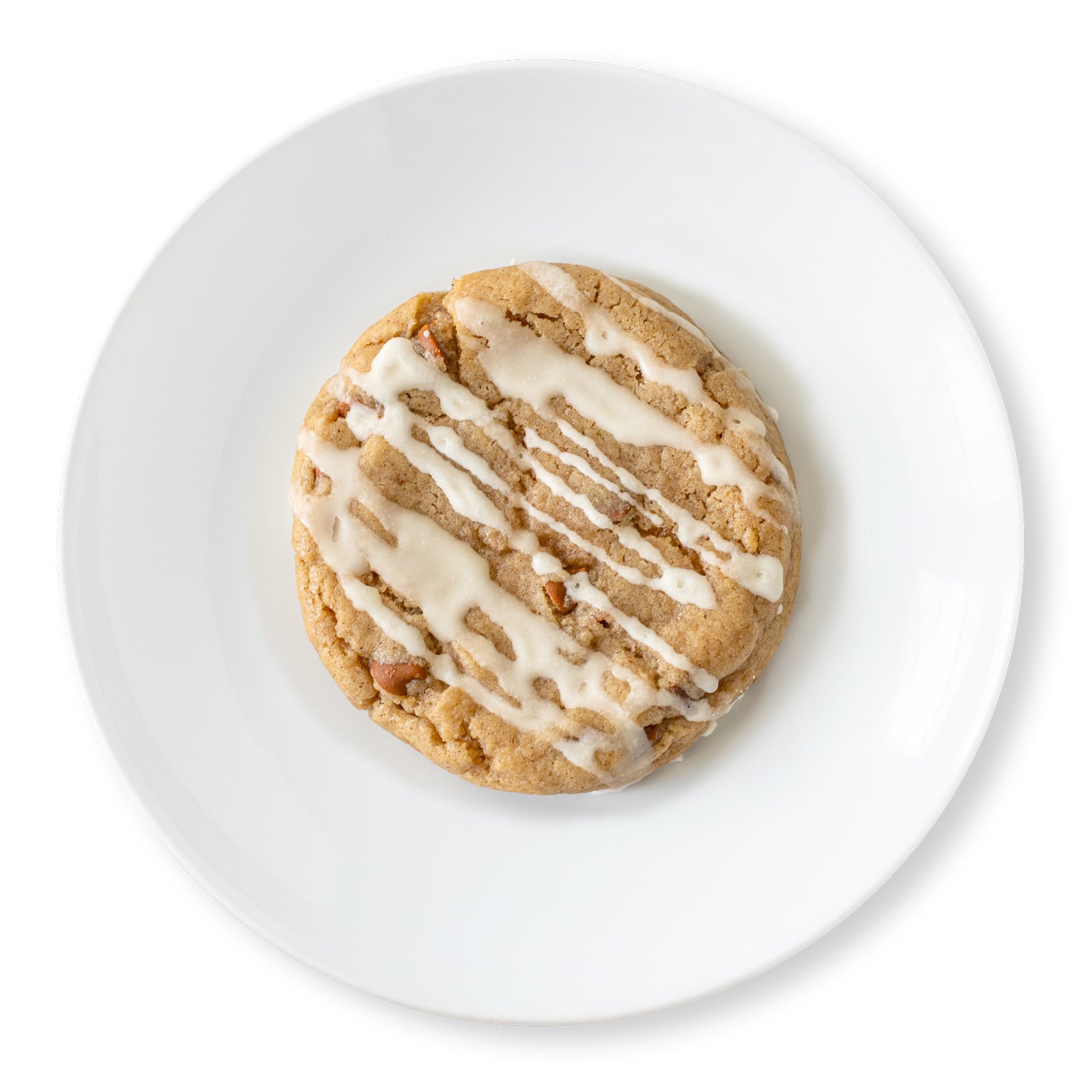 Top-down view of an Apple Cider Cookie with a glossy apple cider glaze, dotted with cinnamon baking chips for a cozy autumn look.