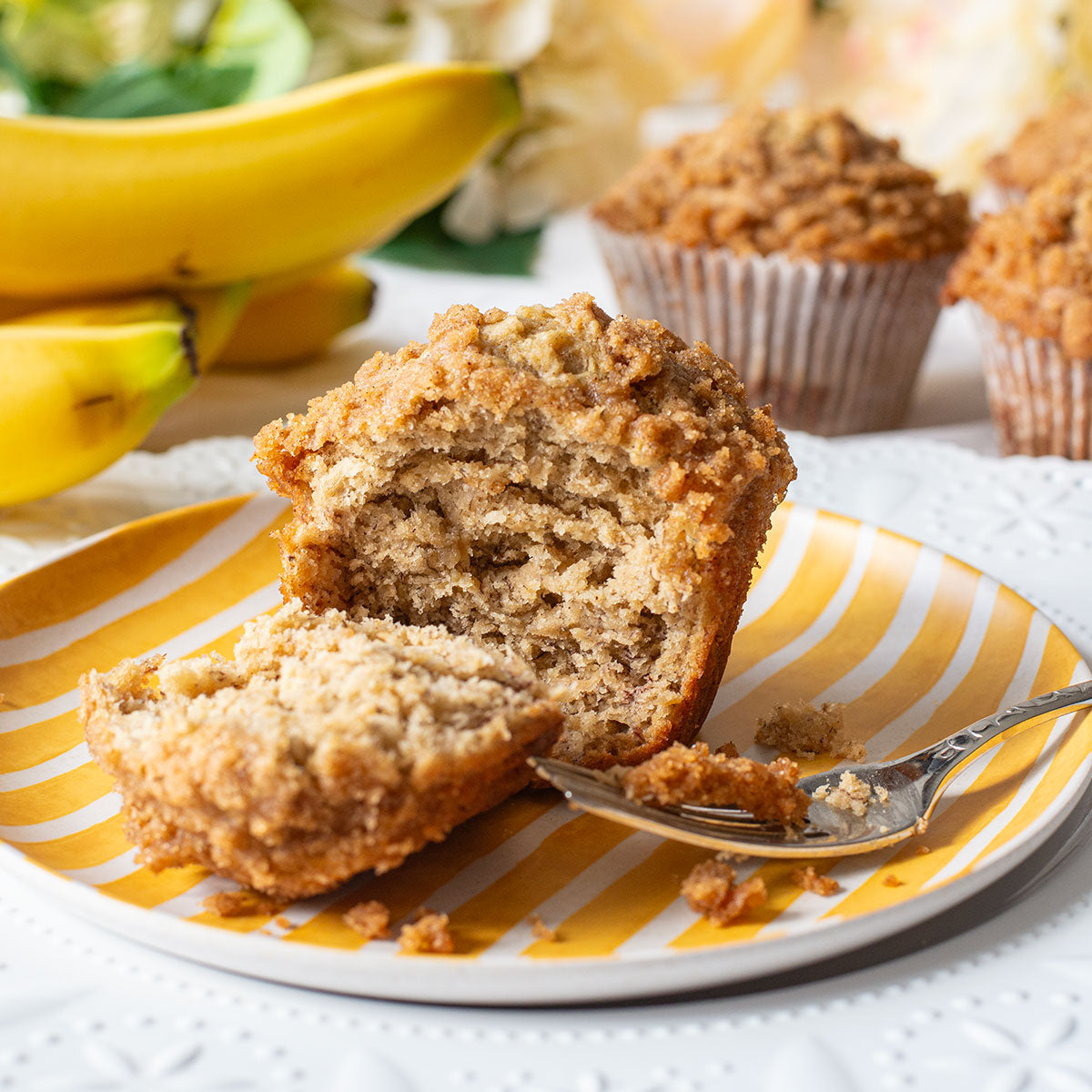 A scrumptious image of a Jumbo Banana Crumb Muffin, highlighting its moist banana-infused base and mouthwatering crumb topping made with brown sugar and cinnamon.