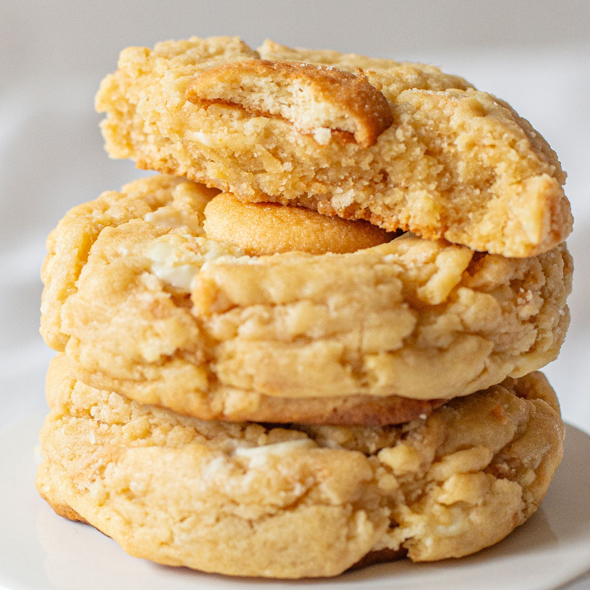 A close-up image of a banana pudding cookie topped with a Nilla Wafer