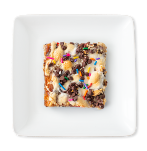 A colorful and delicious Banana Split Brownie viewed from above, featuring layers of fudgy brownie, banana bar, and assorted toppings, evoking summertime sweetness in every bite.