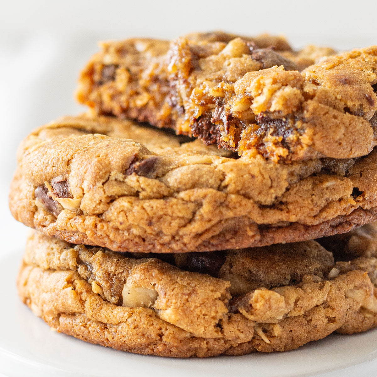 An enticing image of a Big Island Cookie, showcasing its unique blend of rolled oats, coconut flakes, chopped macadamia nuts, semisweet chocolate chips, and a hint of espresso, offering a taste of tropical paradise.