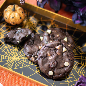 Black Cherry Noir Cookies on a tray with Halloween flowers and decorations surrounding them