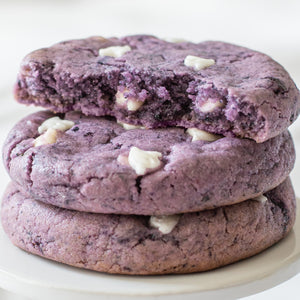 Stack of 3 Boo-Berry cookies with white  chocolate chunks on a white plate