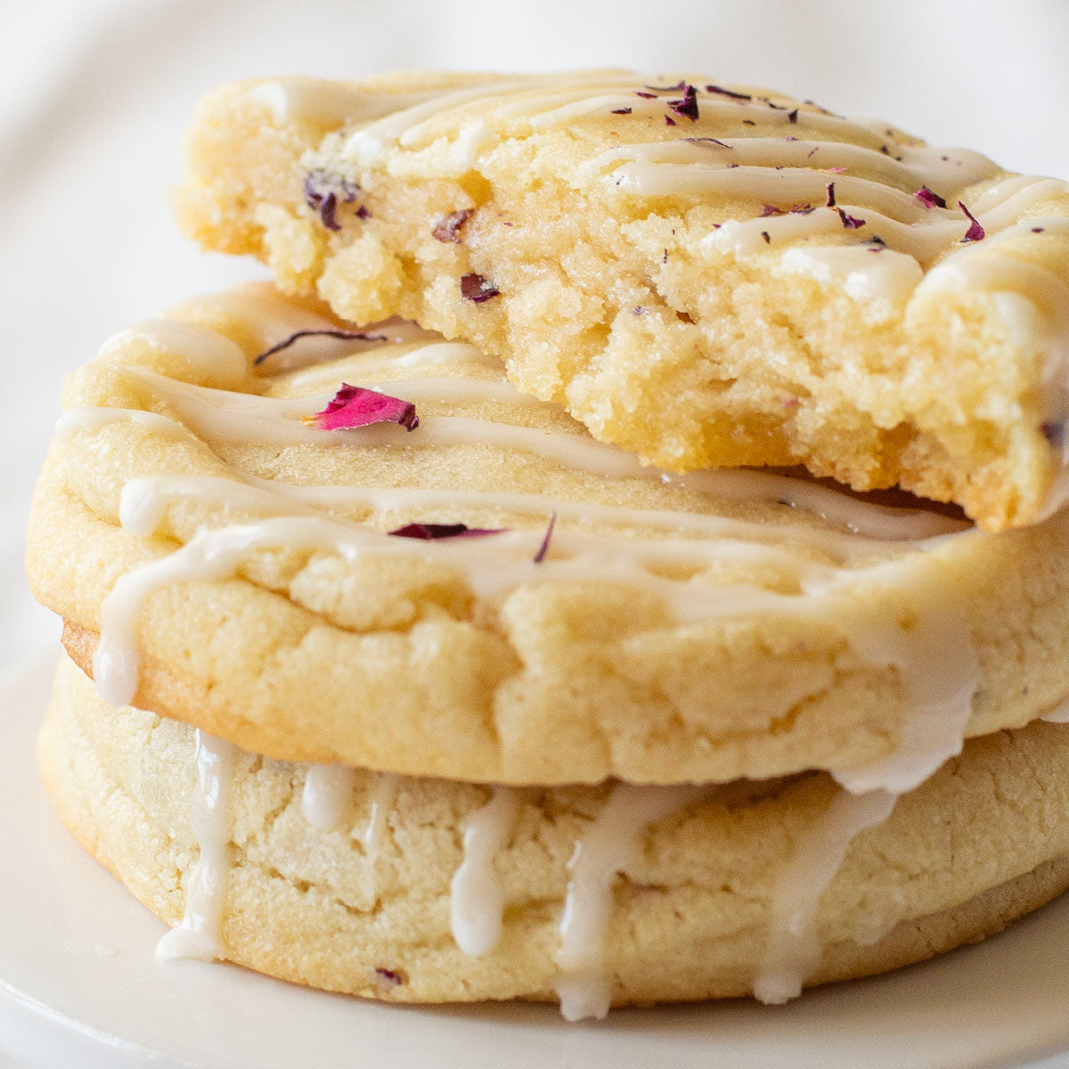 Overhead view of Champagne & Roses Cookies with a delicate rose petal garnish.
