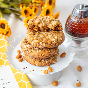 A tantalizing assortment of Hot-Honey Peanut Butter Cookies, featuring their delectable blend of sweet and spicy flavors, combining chunky peanut butter, hot honey, honey-roasted peanuts, and a touch of chili pepper flakes, offering a unique and satisfying treat for peanut butter enthusiasts.