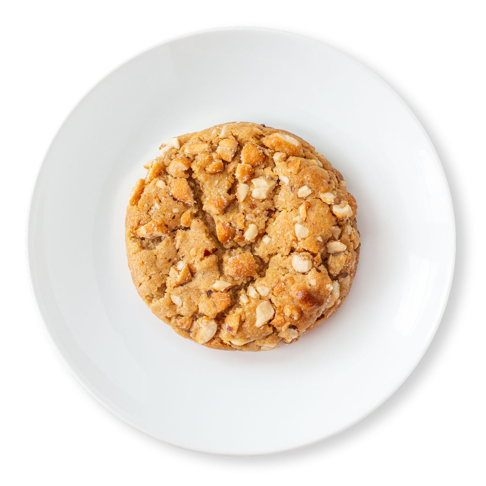 A mouthwatering image of a Hot-Honey Peanut Butter Cookie, showcasing its golden-brown exterior, chunky texture from the chopped honey-roasted peanuts, and a sprinkle of chili pepper flakes for a touch of heat.