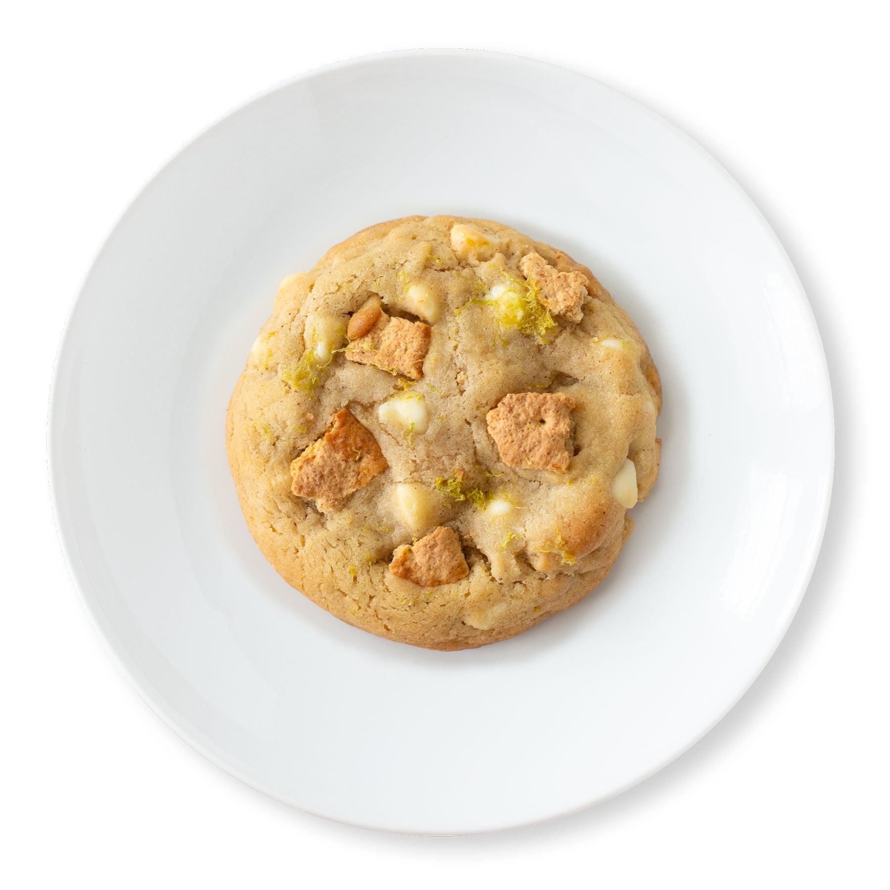 Overhead shot of a Key Lime Cookie on a plate, showing a soft, crinkled top with visible white chocolate chips and graham cracker bits.