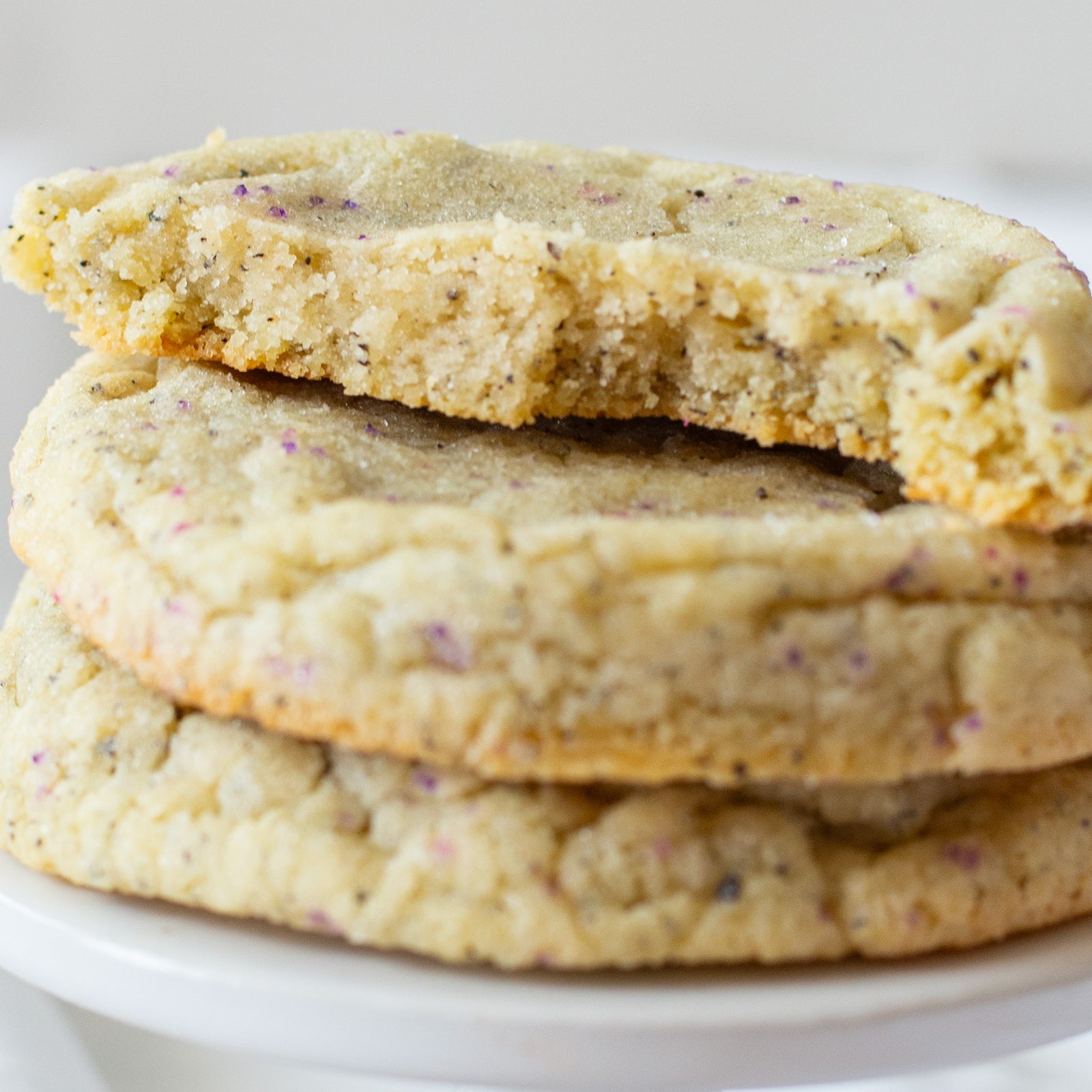Overhead view of a Lavender Earl Grey cookie from Cravings Baked Goods, a chewy buttery sugar cookie infused with Earl Grey tea and lavender flavor, rolled in sugar.