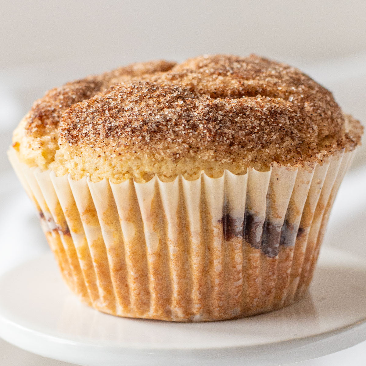 An enticing image of a Jumbo Nutella Muffin, showcasing its golden-brown exterior, cinnamon-sugar coating, and a luscious Nutella filling, tempting you with its indulgent sweetness.
