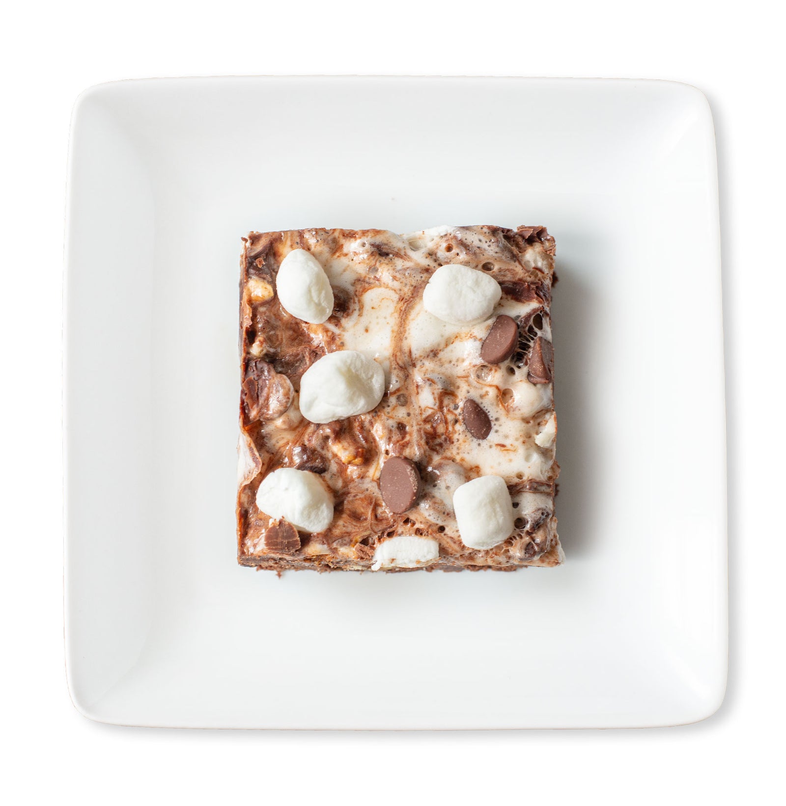 A close-up image of a fudgy Rocky Road Brownie with toasted walnuts and a gooey mixture of marshmallows and chocolate chips on top.