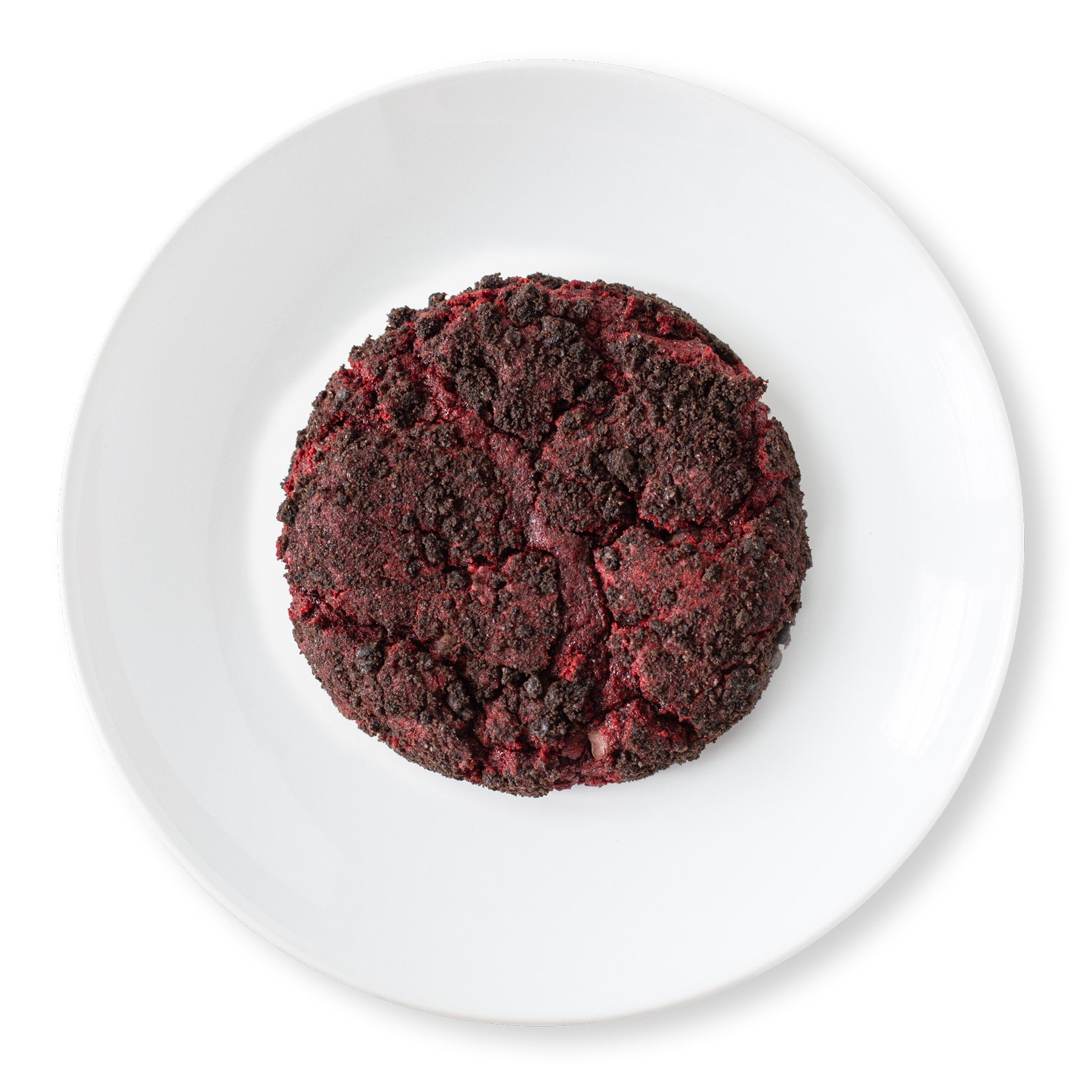 Velvet Vortex Cookie shot from above, showing a red velvet cookie with mini chocolate chips and a dark Oreo crust.