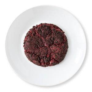 Velvet Vortex Cookie shot from above, showing a red velvet cookie with mini chocolate chips and a dark Oreo crust.